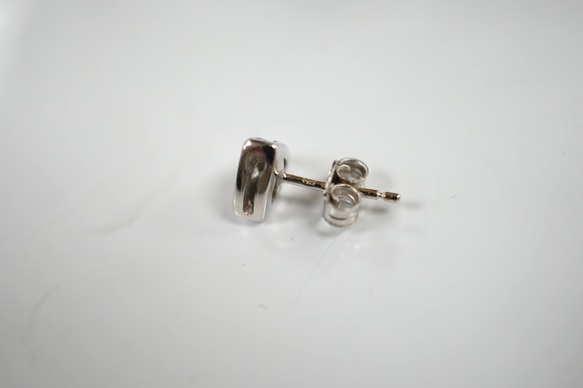 A modern pair of 18ct white gold and single stone diamond set ear studs, 6mm, gross weight 2.8 grams. Condition - fair to good